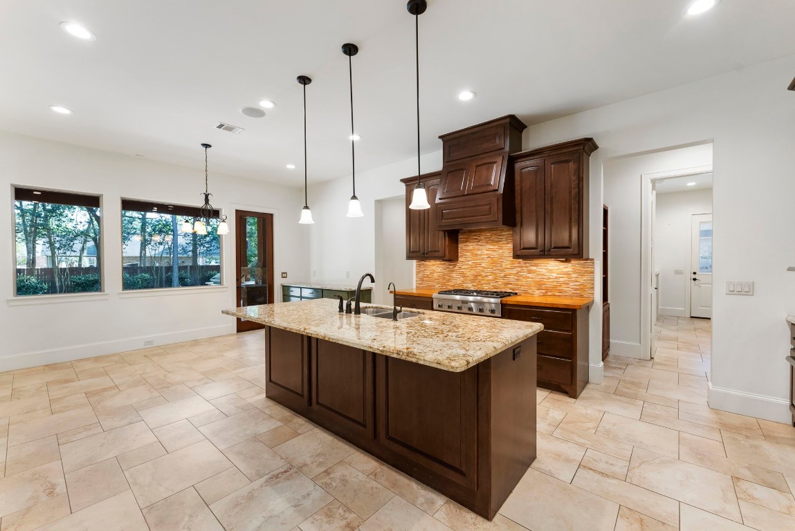 3810 Oreana Court Spring, TX 77386 - Photo 18 of 44 a large kitchen with kitchen island a sink a counter top space appliances and cabinets
