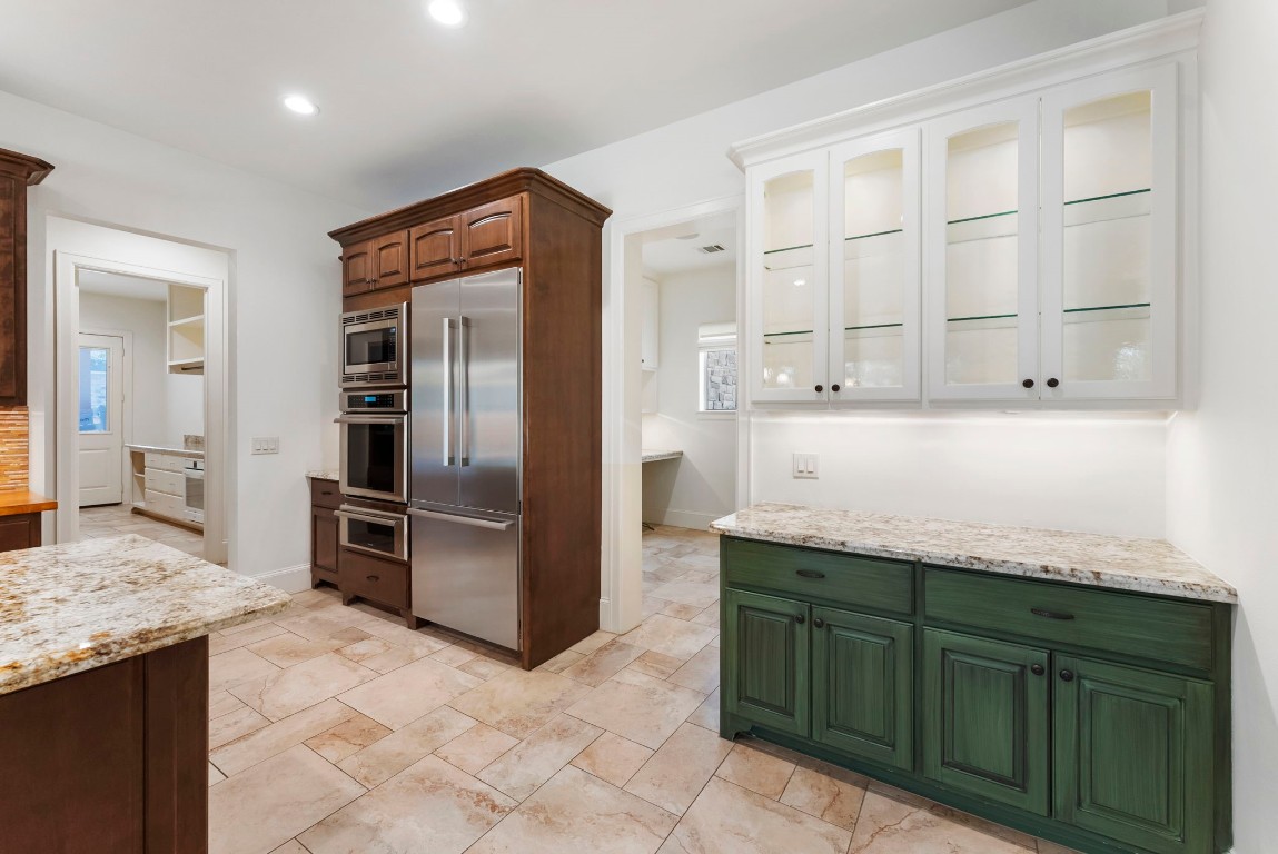 3810 Oreana Court Spring, TX 77386 - Photo 19 of 44 a kitchen with granite countertop cabinets and refrigerator