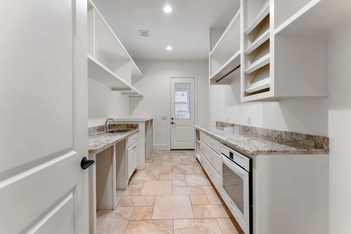 3810 Oreana Court Spring, TX 77386 - Photo 22 of 44 a kitchen with granite countertop a sink stove and cabinets