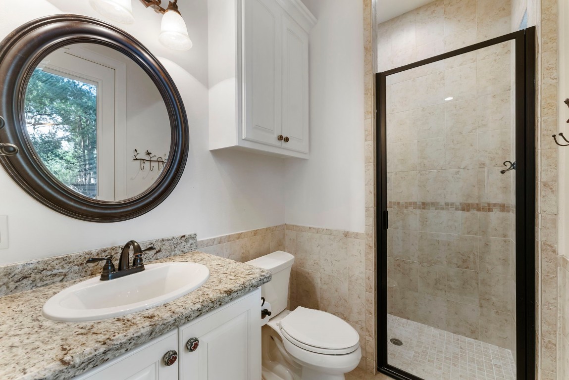 3810 Oreana Court Spring, TX 77386 - Photo 24 of 44 a bathroom with a granite countertop sink a mirror and a toilet