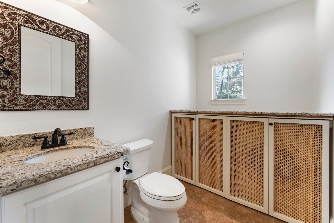 3810 Oreana Court Spring, TX 77386 - Photo 33 of 44 a bathroom with a granite countertop toilet sink and mirror