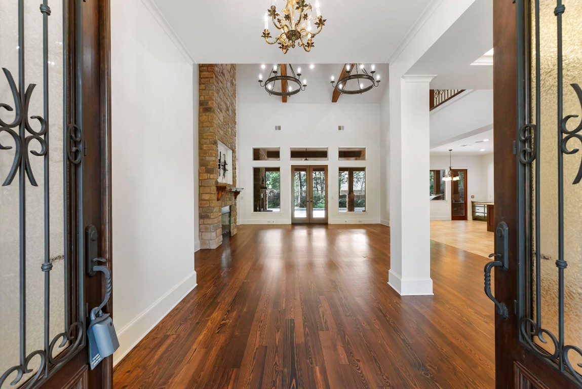 3810 Oreana Court Spring, TX 77386 - Photo 4 of 44 a view of a hallway with wooden floor and a chandelier