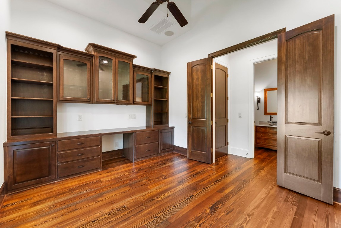 3810 Oreana Court Spring, TX 77386 - Photo 9 of 44 a view of walk in closet with wooden floor and workspace
