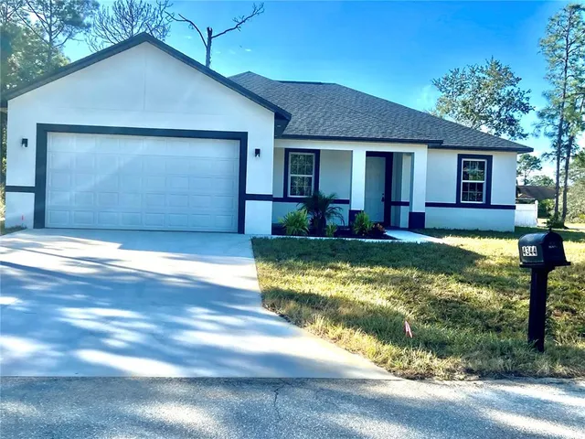 a view of a house with swimming pool next to a yard