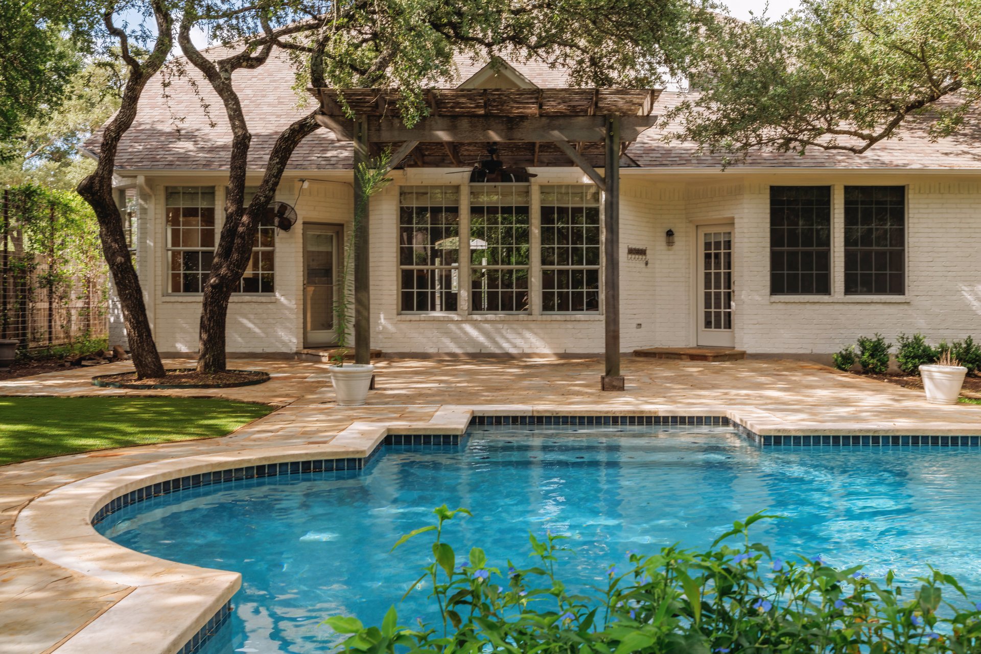 5512 Ballenton Lane Austin, TX 78739 - Photo 37 of 40 An inviting backyard oasis offers a sparkling pool and a comfortable patio with a shaded pergola.