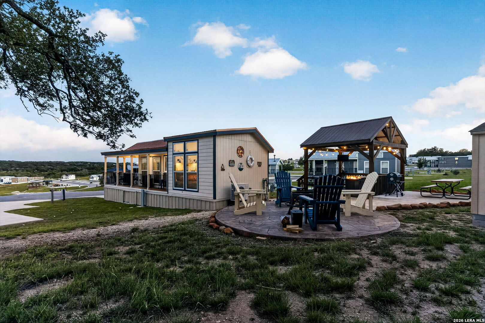 5386 Ranch Road 1376, Unit 64 Fredericksburg, TX 78624 - Photo 20 of 45 a view of a house with backyard sitting area and garden