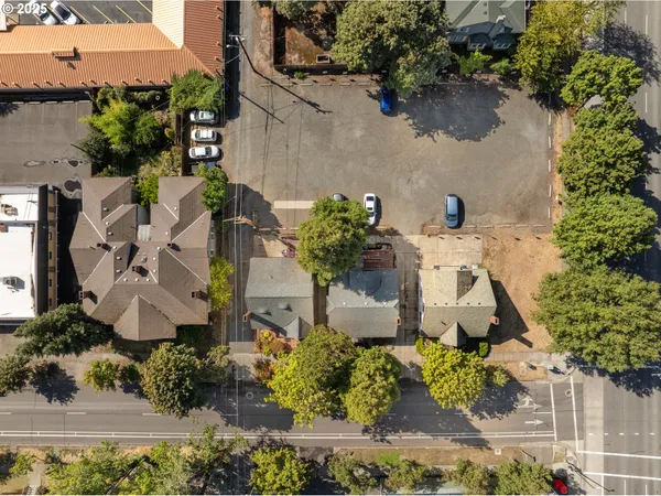 an aerial view of a house with a yard and lake view