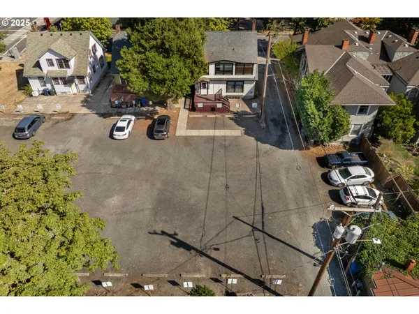 an aerial view of a house with a yard and lake view