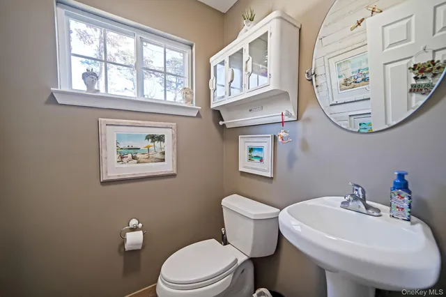 a white toilet sitting next to a bathroom sink