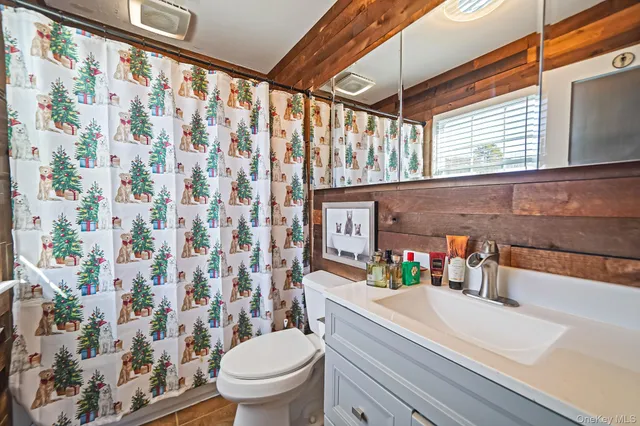 a bathroom with a sink a toilet and shower curtain