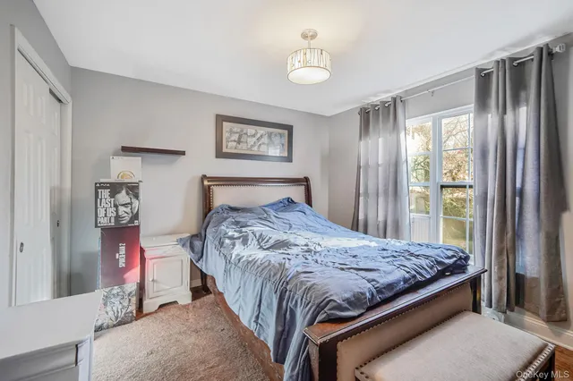 a bedroom with bed and large window