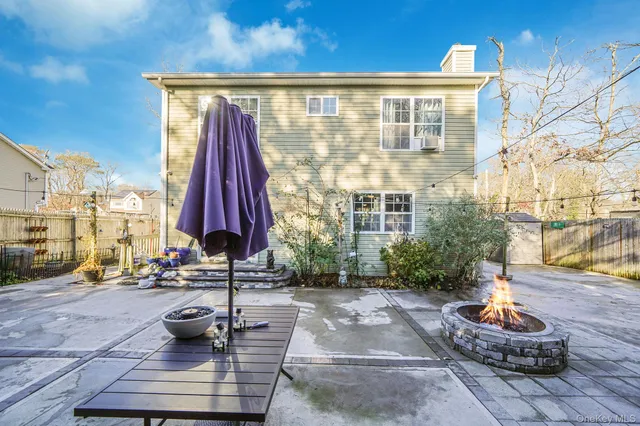 a view of a building with sitting area and garden