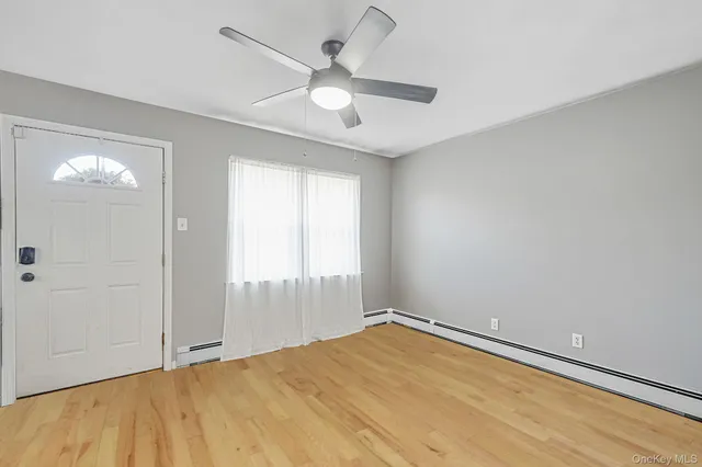 wooden floor in an empty room with a window