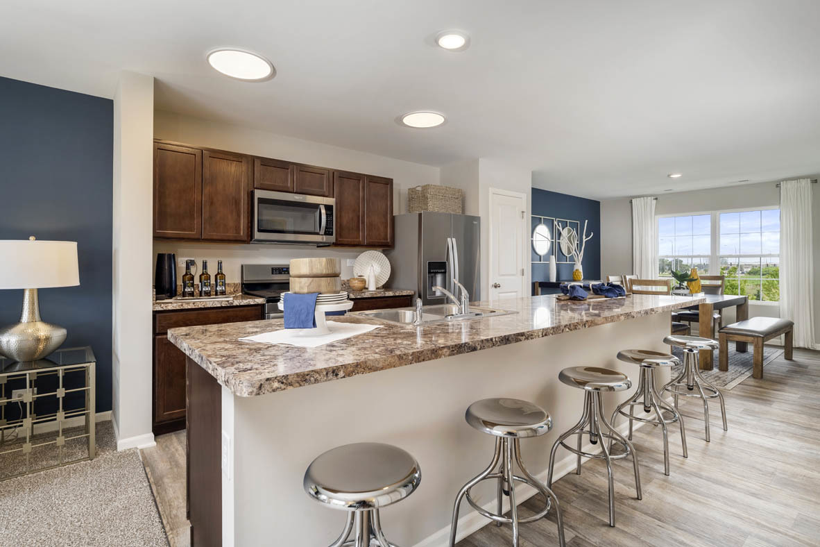 2368 Alison Avenue Pingree Grove, IL 60140 - Photo 4 of 20 a kitchen with stainless steel appliances granite countertop a stove top oven a sink a dining table and chairs with wooden floor