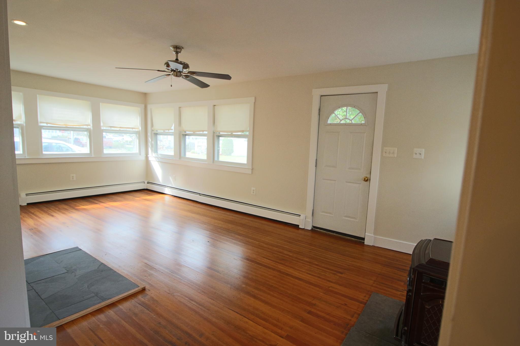 1606 Ruxton Road Edgewater, MD 21037 - Photo 13 of 26 wooden floor in an empty room with a window