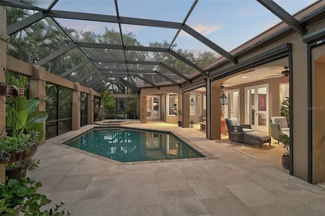 a open kitchen with stainless steel appliances granite countertop a stove top oven a refrigerator a sink and white cabinets with wooden floor