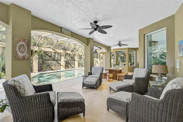 an aerial view of residential house with outdoor space and trees all around