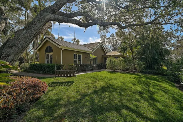 a view of a tennis ground with large trees