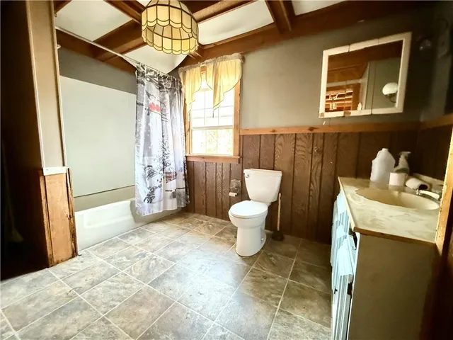 a spacious bathroom with a toilet sink and shower