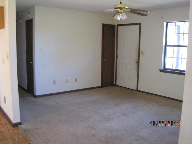 657 River Road Fort Valley, GA 31030 - Photo 3 of 13 an empty room with chandelier fan and windows