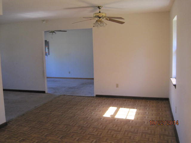 657 River Road Fort Valley, GA 31030 - Photo 5 of 13 an empty room with a window and chandelier fan