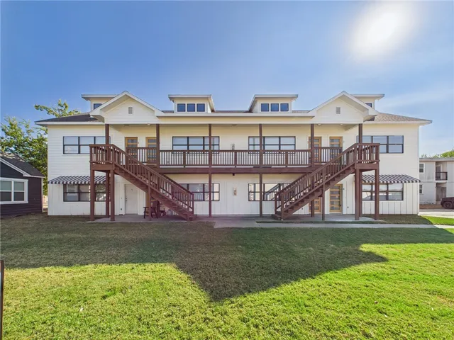 a view of a house with a yard and a porch