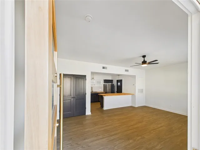 a view of a kitchen with a sink and a refrigerator