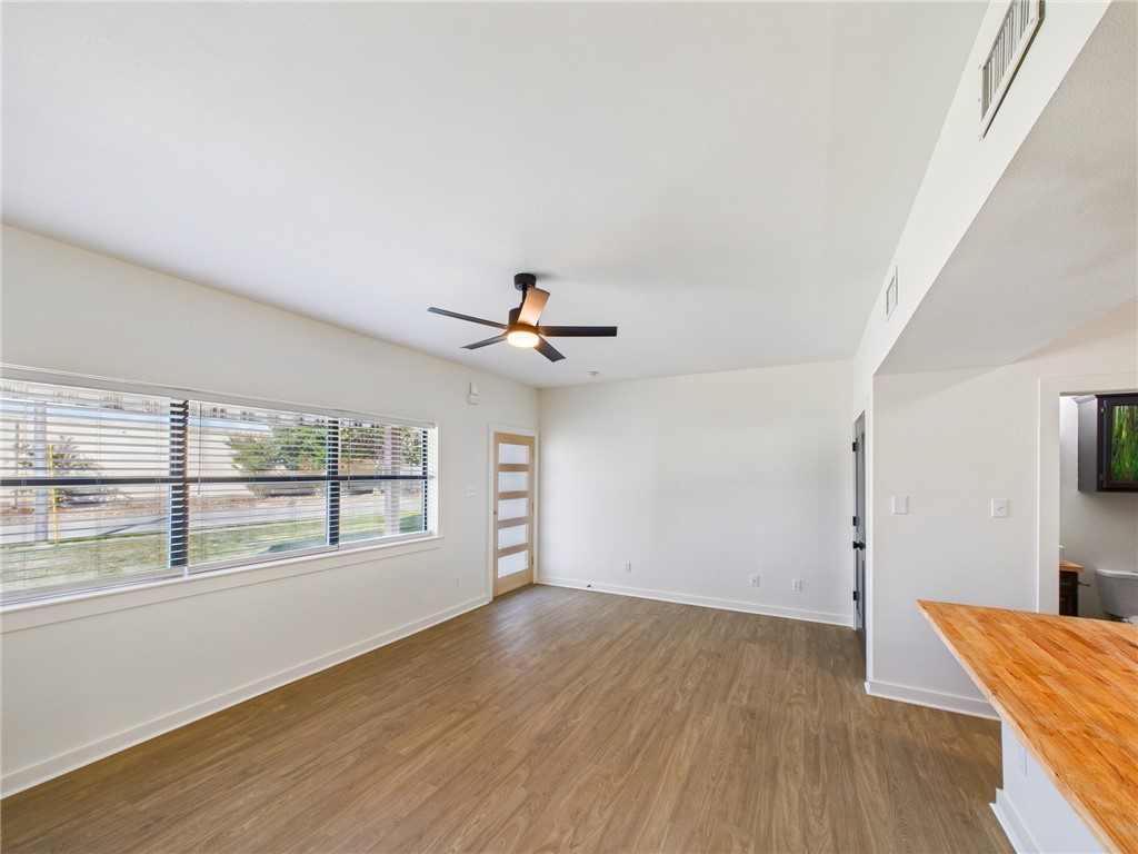 309 Mobile Avenue, Unit 4 Bryan, TX 77801 - Photo 6 of 12 wooden floor in an empty room with a window