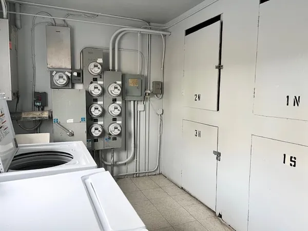 a view of a storage and utility room with washer and dryer