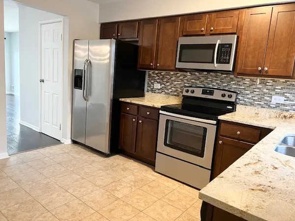 a kitchen with a stove microwave and refrigerator