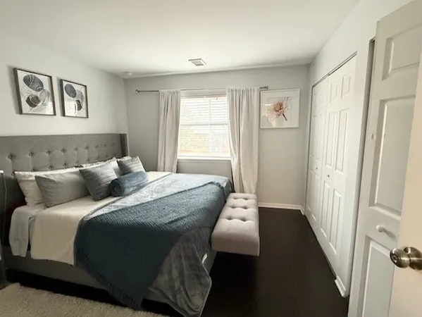 a bed sitting in a bedroom next to a window