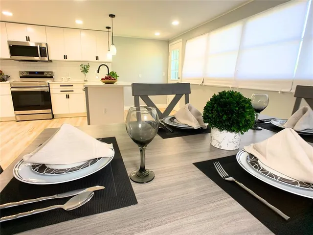 a view of a dining room with furniture and window