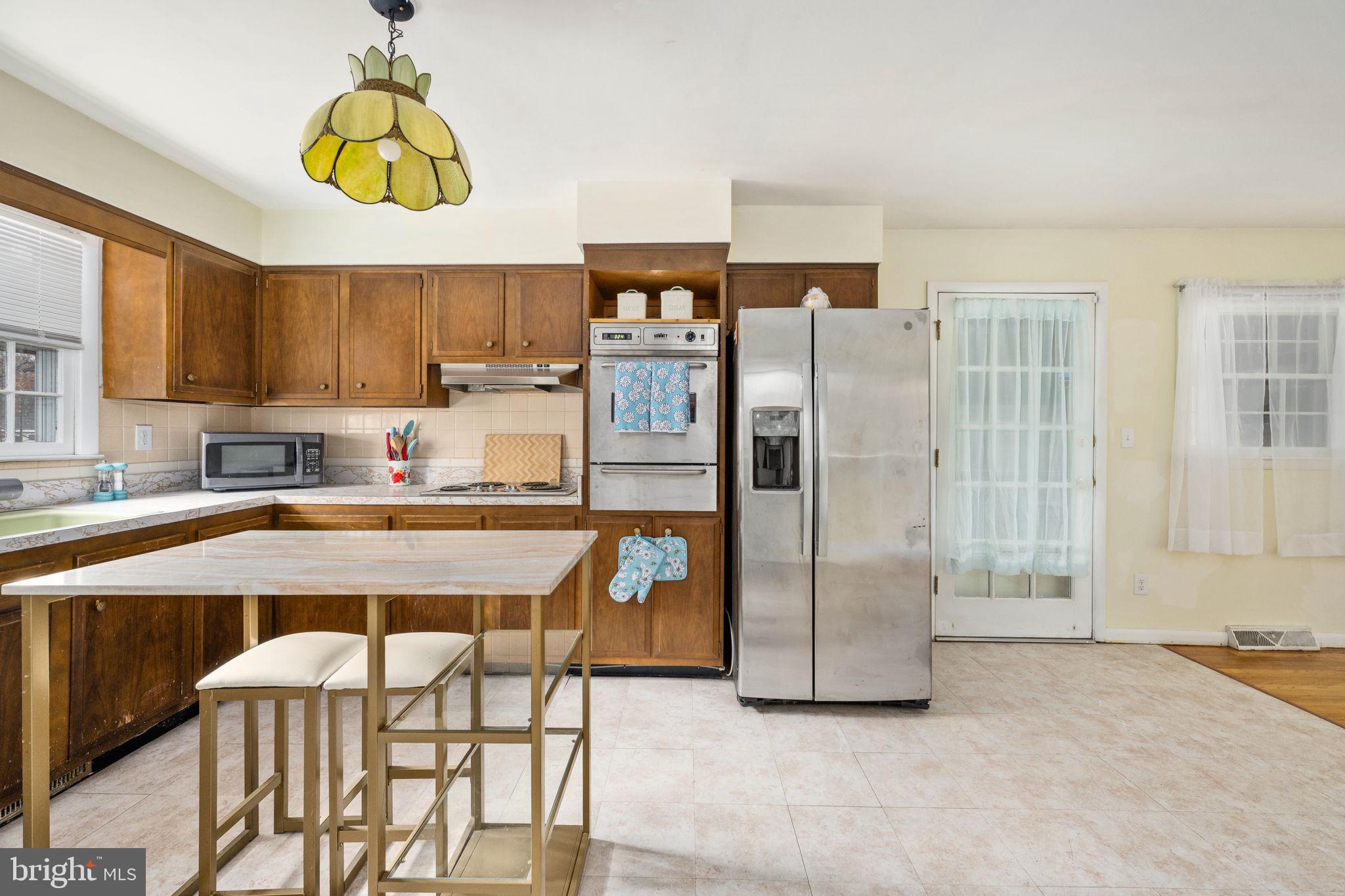 128 11th Street Colonial Beach, VA 22443 - Photo 24 of 58 a kitchen with refrigerator and window