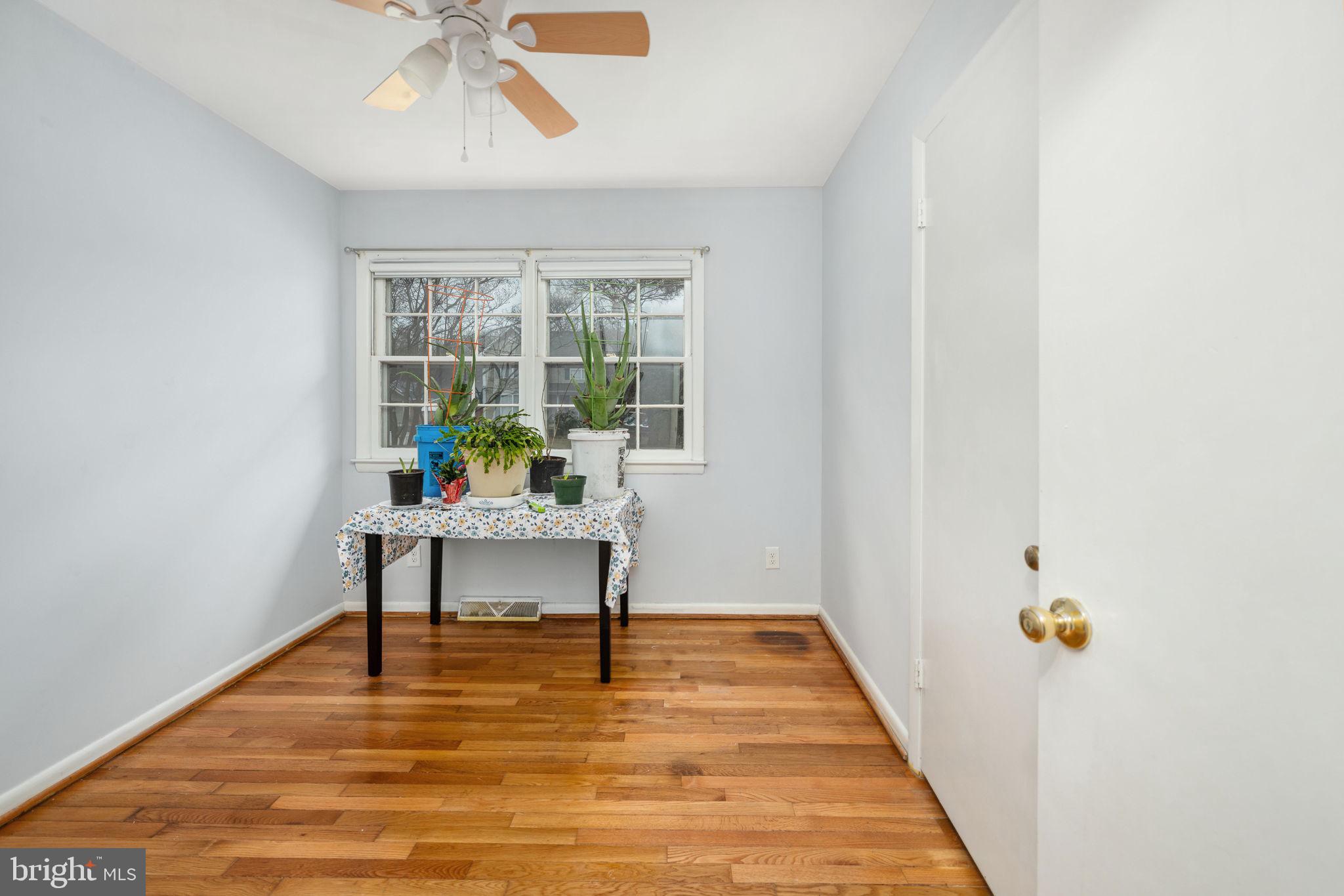128 11th Street Colonial Beach, VA 22443 - Photo 29 of 58 a view of a hallway with wooden floor and a potted plant