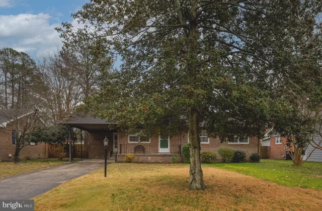 a front view of a building with a garden