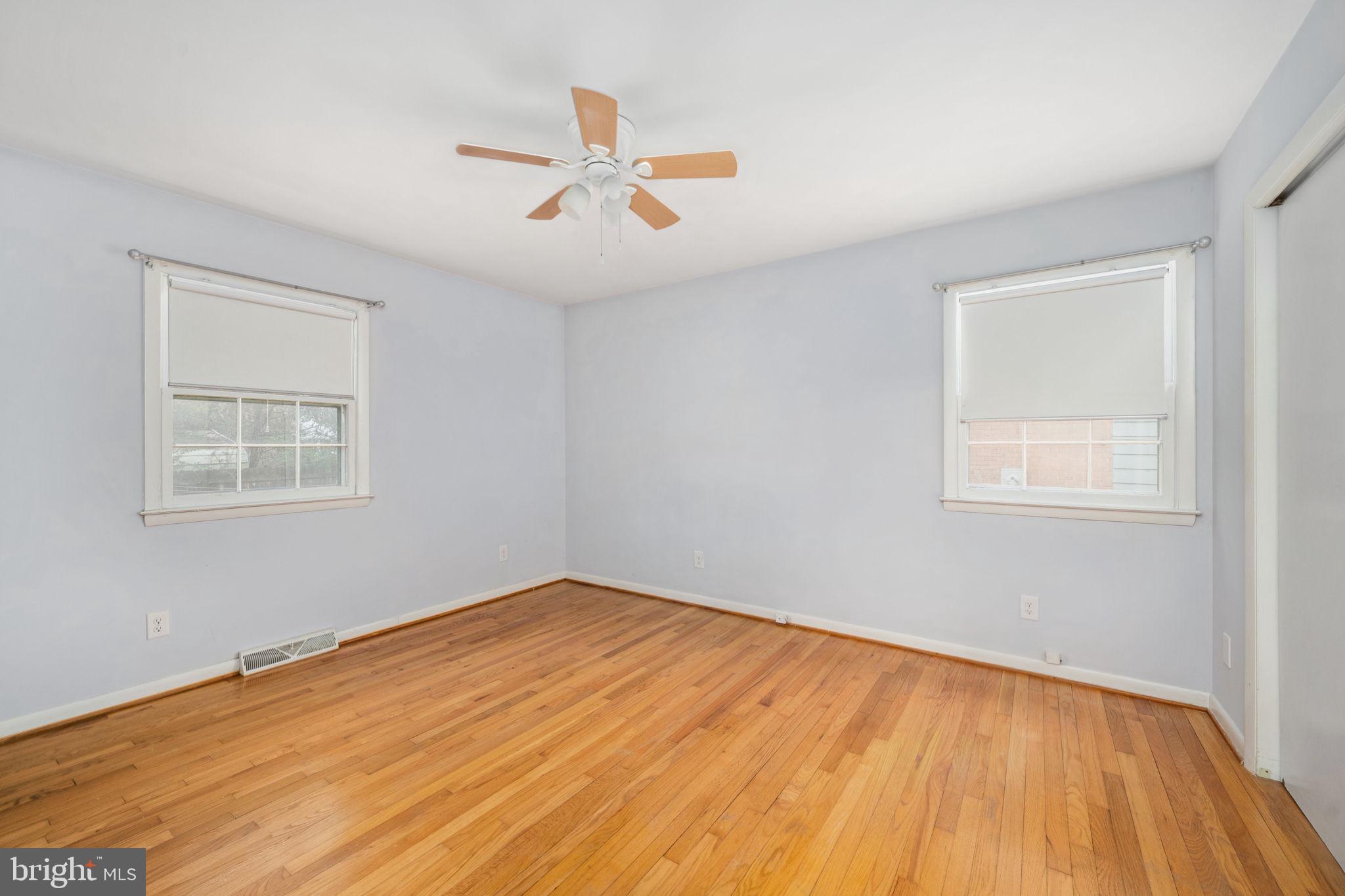 128 11th Street Colonial Beach, VA 22443 - Photo 33 of 58 a view of empty room with wooden floor and fan