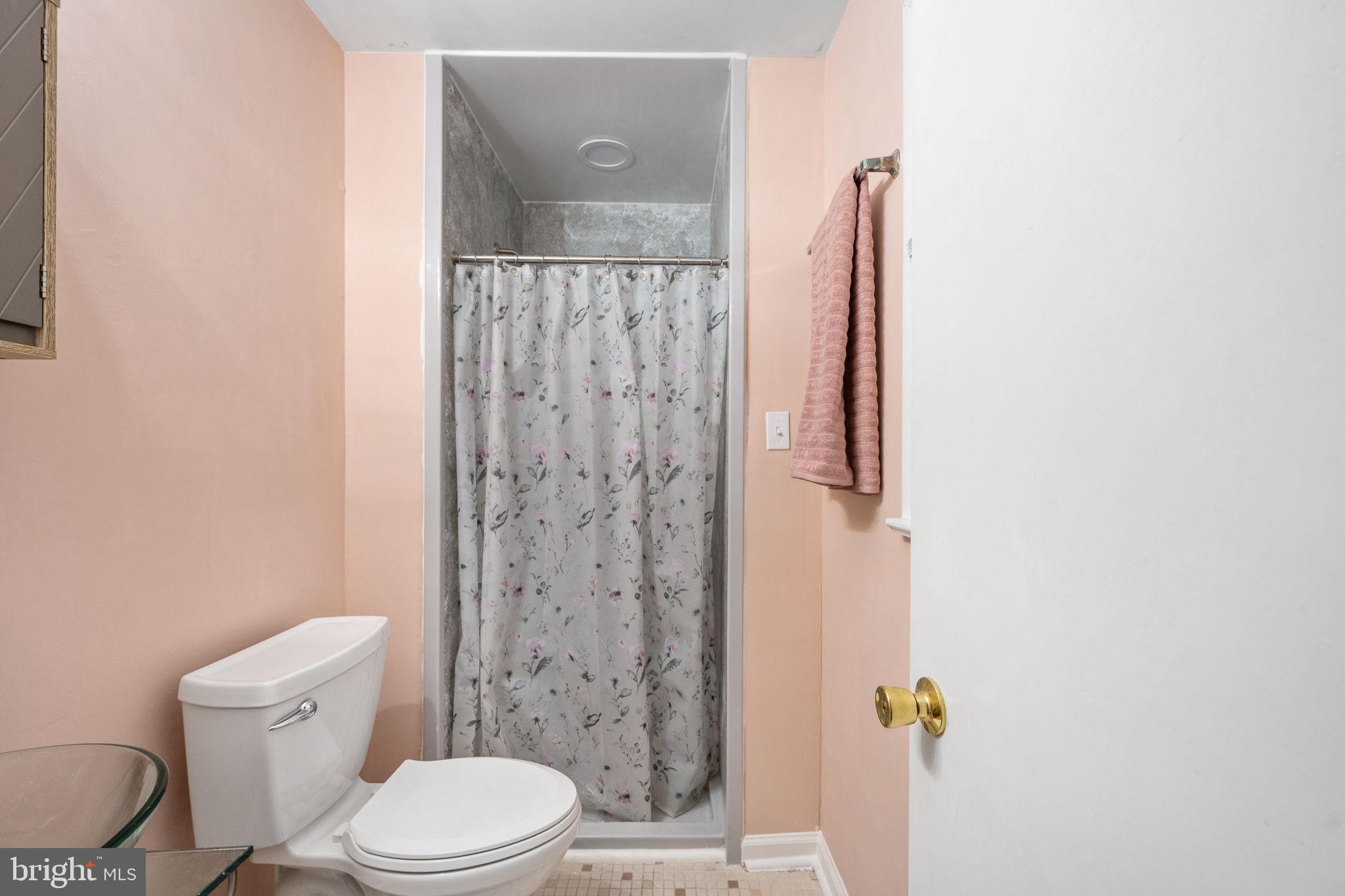 128 11th Street Colonial Beach, VA 22443 - Photo 36 of 58 a white toilet sitting next to a bathroom sink