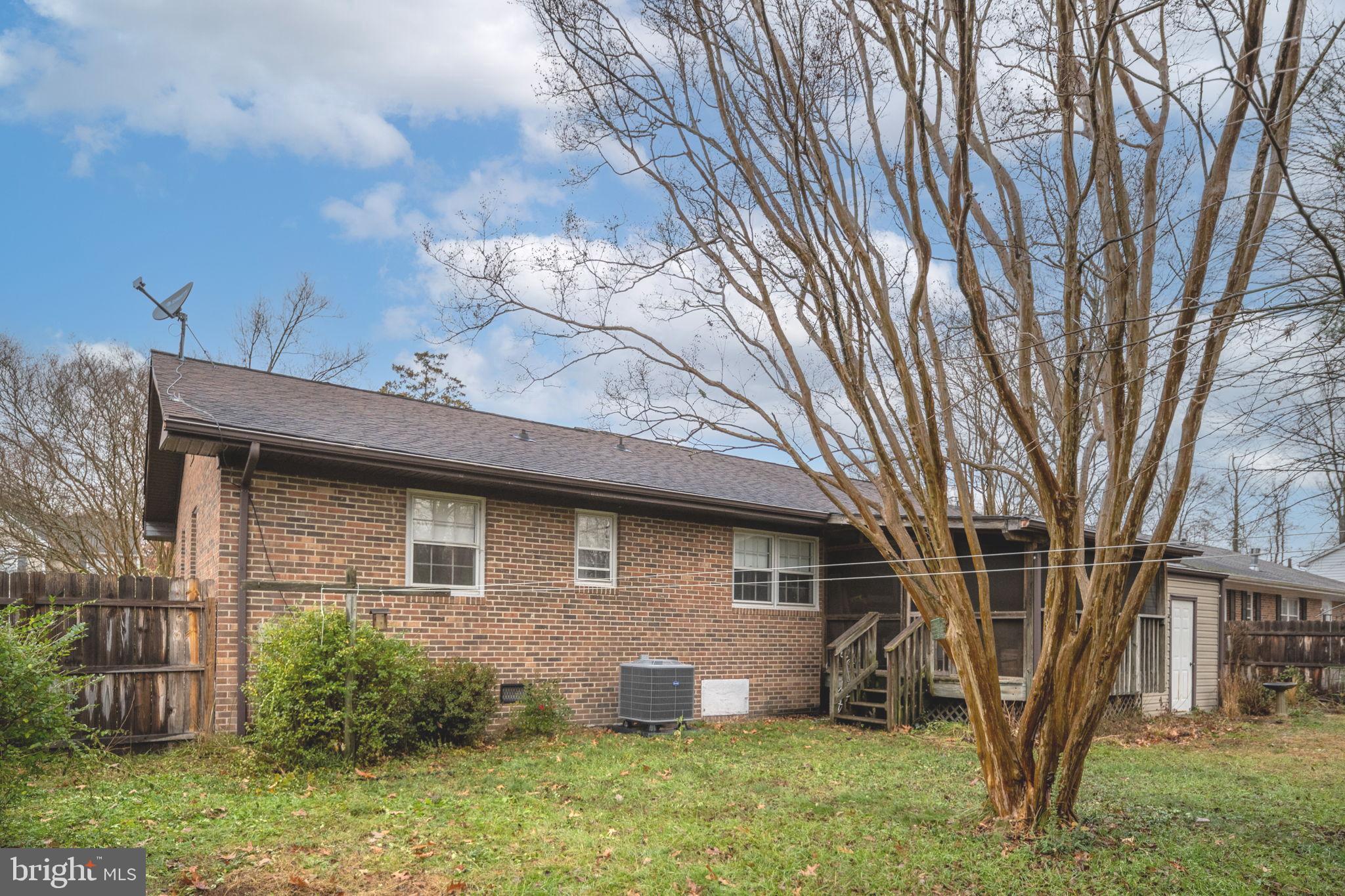 128 11th Street Colonial Beach, VA 22443 - Photo 52 of 80 a brick house with a large tree