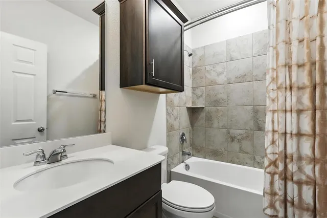 a bathroom with a sink a toilet and bathtub