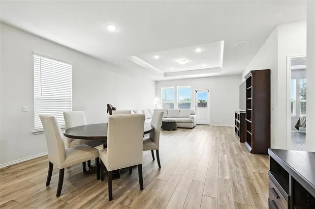 a view of a dining room with furniture and a window
