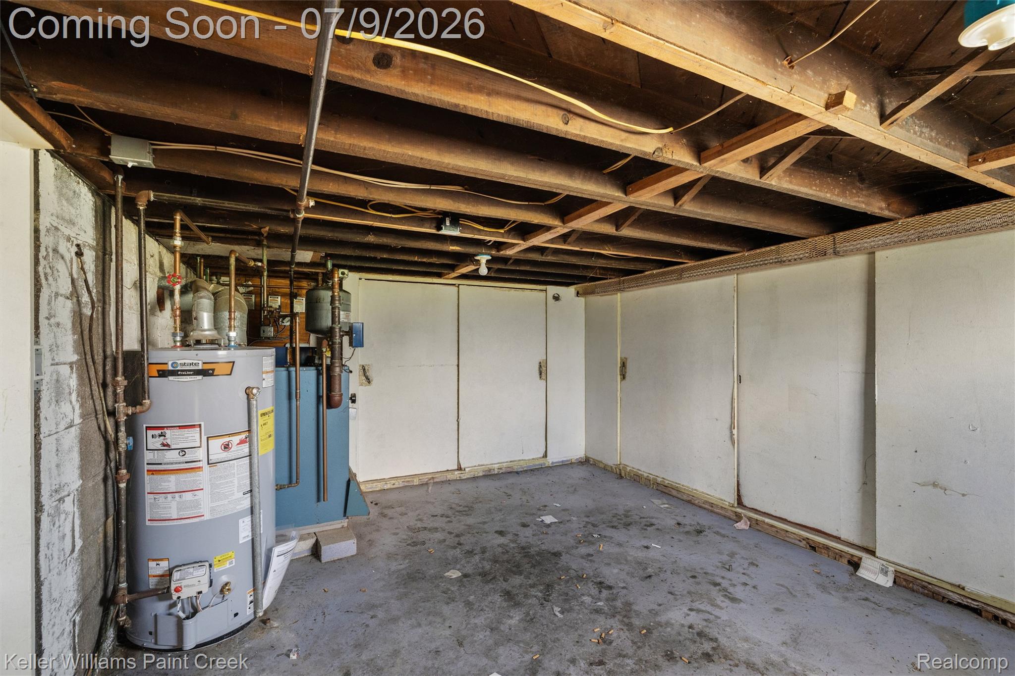 28780 School Section Road Richmond, MI 48062 - Photo 32 of 50 Basement area featuring exposed wood joists, a water heater, and a concrete floor