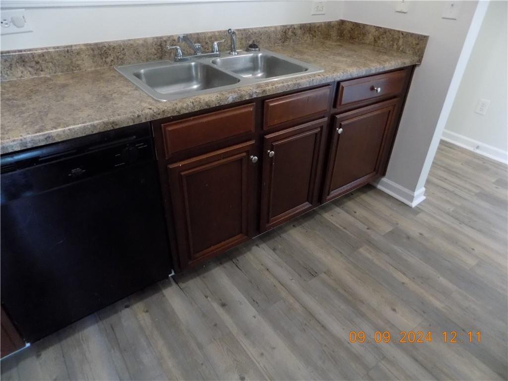 5509 Sable Way Atlanta, GA 30349 - Photo 13 of 37 a room with granite countertop cabinets sink and wooden floor