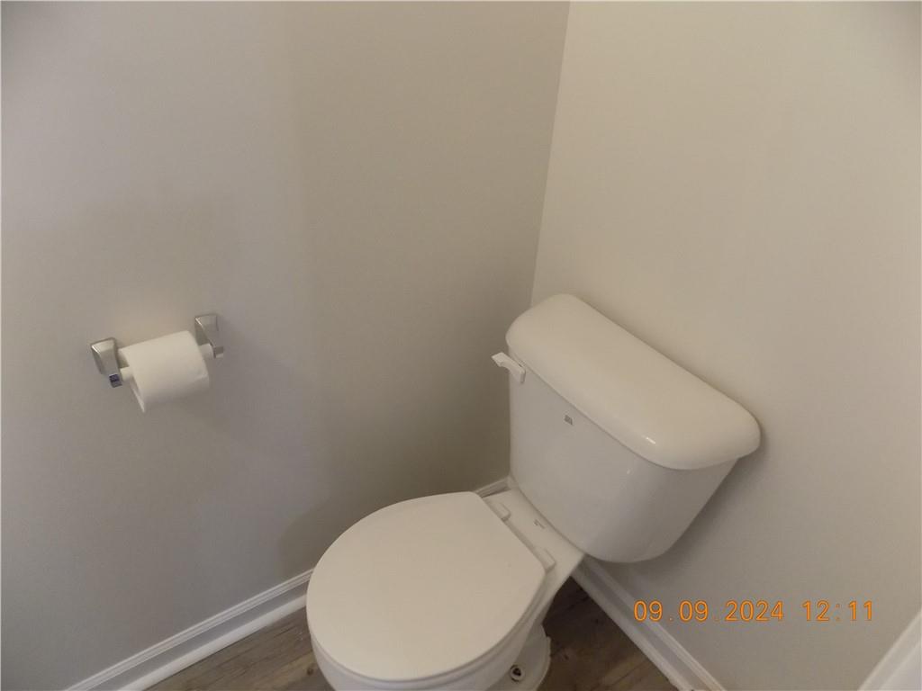 5509 Sable Way Atlanta, GA 30349 - Photo 18 of 37 a white toilet sitting next to a white wall