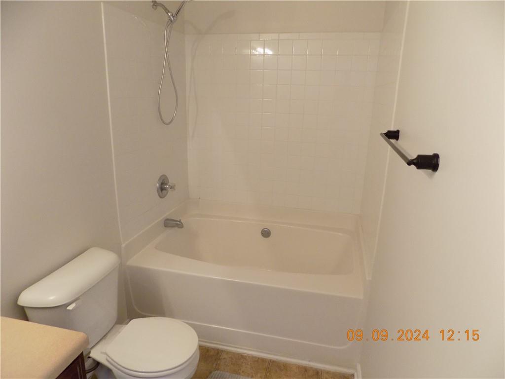 5509 Sable Way Atlanta, GA 30349 - Photo 30 of 37 a white toilet and tub sitting next to a bathroom sink