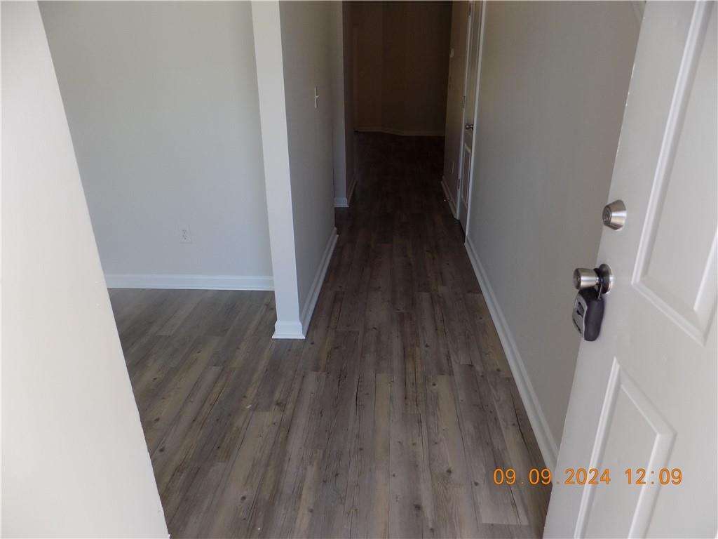 5509 Sable Way Atlanta, GA 30349 - Photo 4 of 37 a view of a hallway with wooden floor and staircase