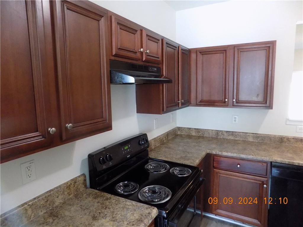 5509 Sable Way Atlanta, GA 30349 - Photo 9 of 37 a kitchen with a stove and a refrigerator