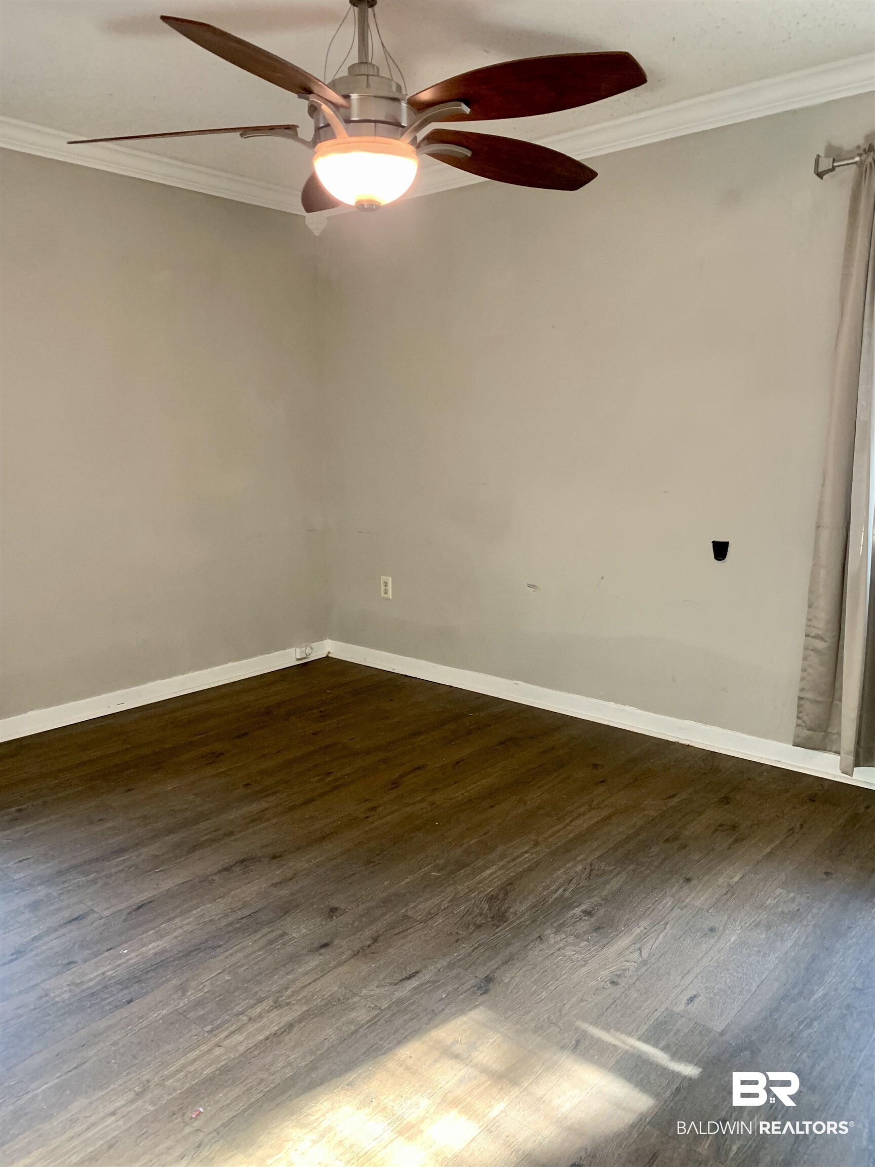 2708 E Road Mobile, AL 36693 - Photo 4 of 12 Spare room with dark hardwood / wood-style floors, ceiling fan, and ornamental molding