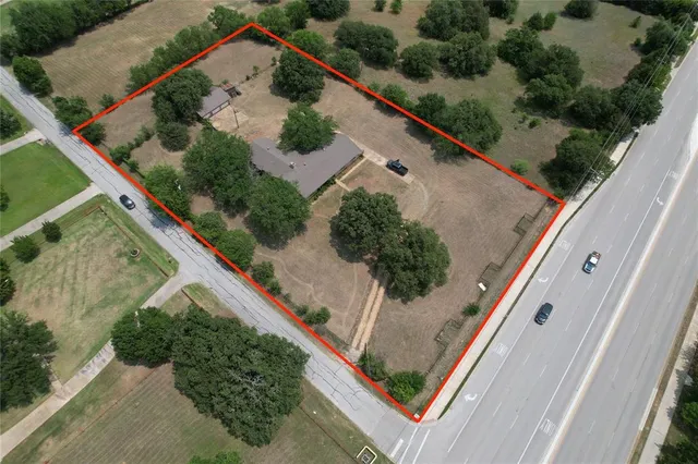 an aerial view of house with a yard