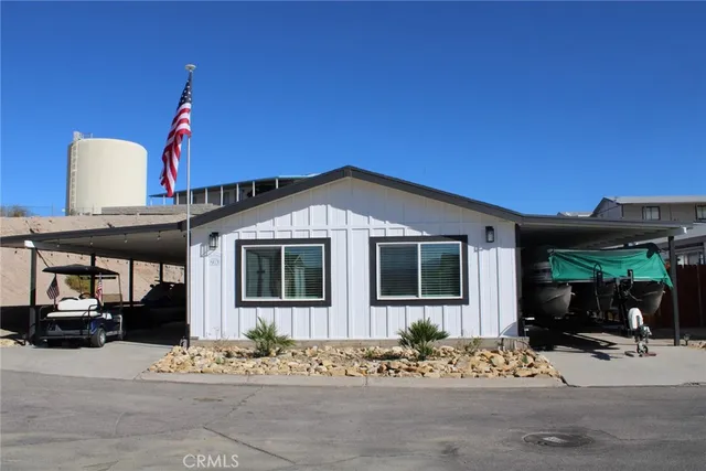a view of a house with street next to a road