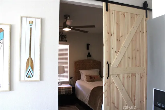 a bedroom with a bed and a painting on the wall